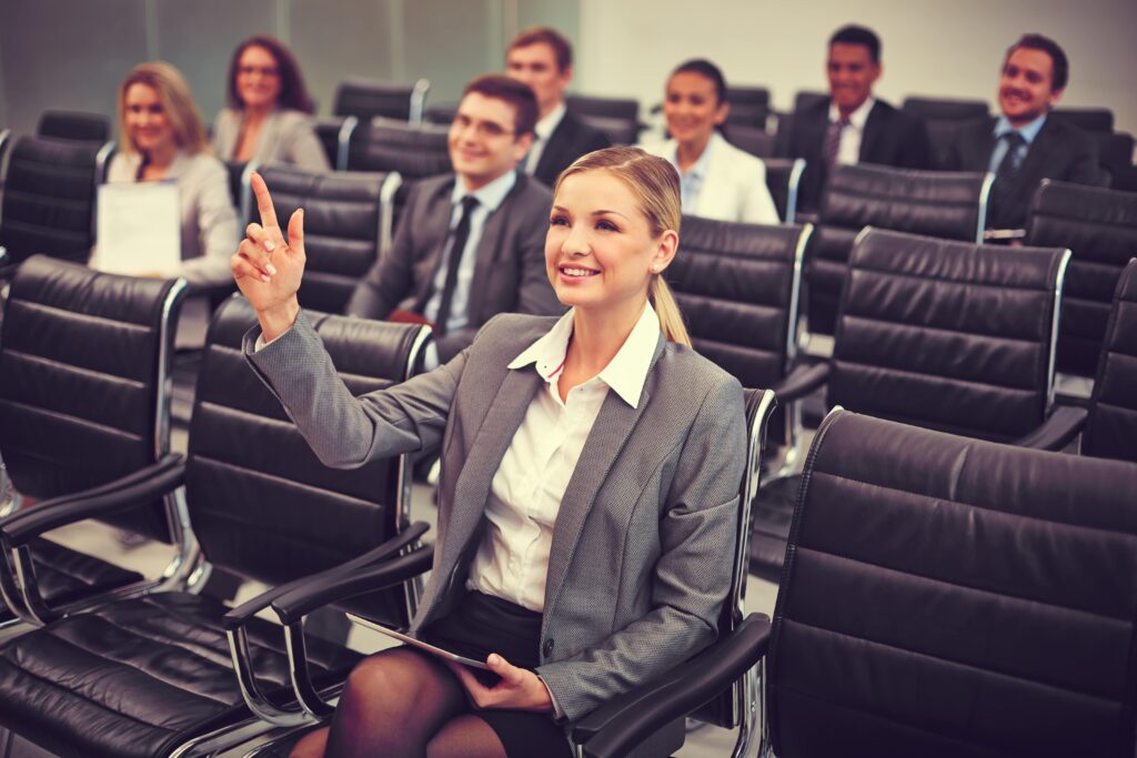 Business woman with question for business speaker